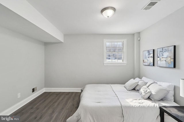 bedroom with dark hardwood / wood-style flooring