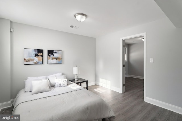 bedroom with dark hardwood / wood-style flooring