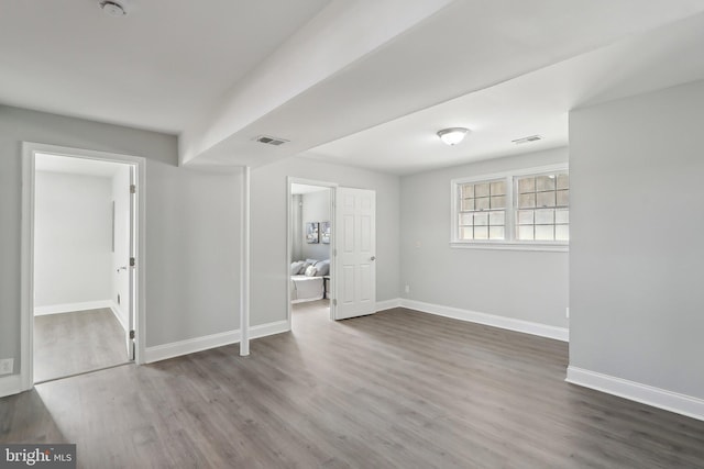 empty room with hardwood / wood-style floors