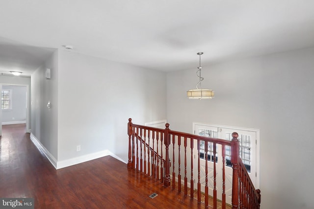 hallway with dark hardwood / wood-style flooring