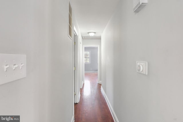 hallway with dark hardwood / wood-style flooring