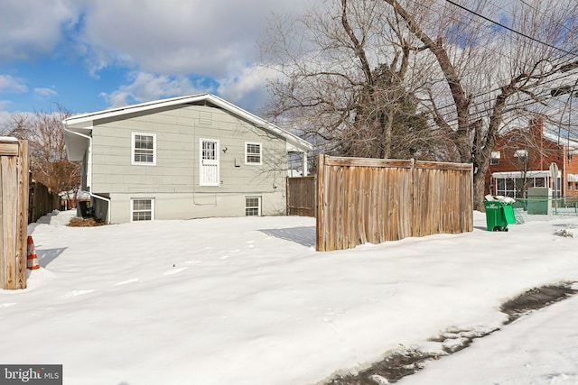 view of snow covered rear of property