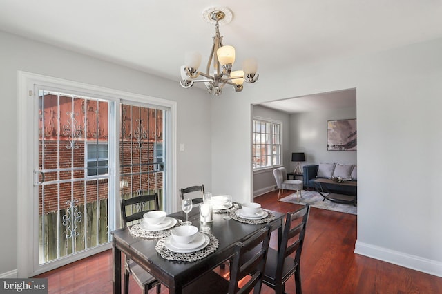 dining room featuring dark hardwood / wood-style flooring and an inviting chandelier