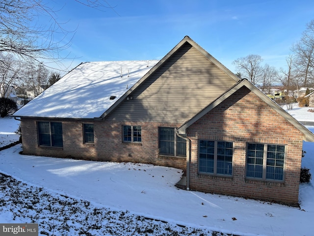 view of snow covered rear of property