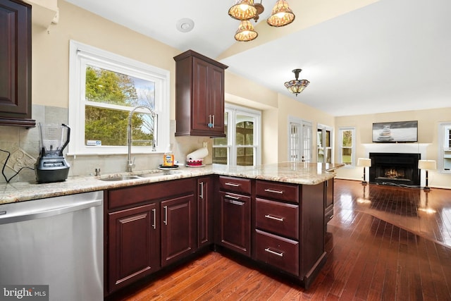 kitchen featuring dishwasher, backsplash, kitchen peninsula, and sink