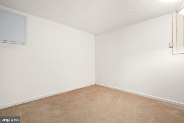 unfurnished room with a textured ceiling and light carpet