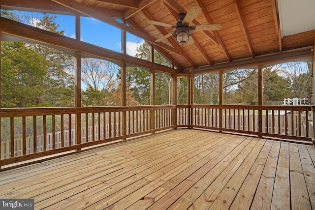 unfurnished sunroom featuring vaulted ceiling with beams, ceiling fan, and wood ceiling