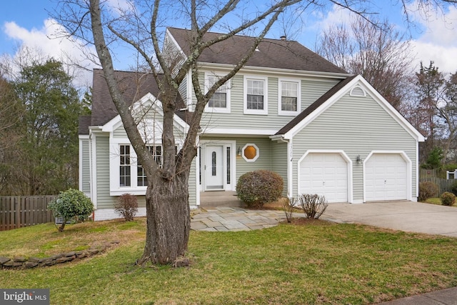 view of front of property featuring a front yard and a garage