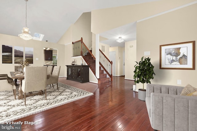 dining room featuring a notable chandelier, dark hardwood / wood-style flooring, and vaulted ceiling