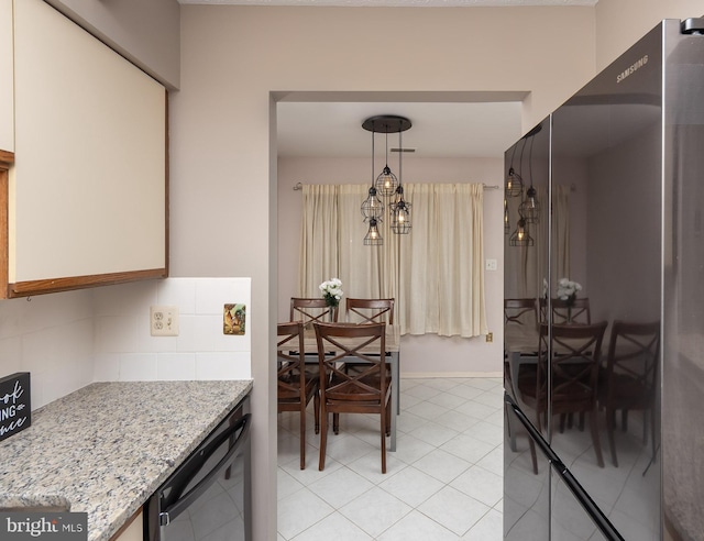 kitchen with pendant lighting, dishwashing machine, light stone counters, white cabinets, and decorative backsplash