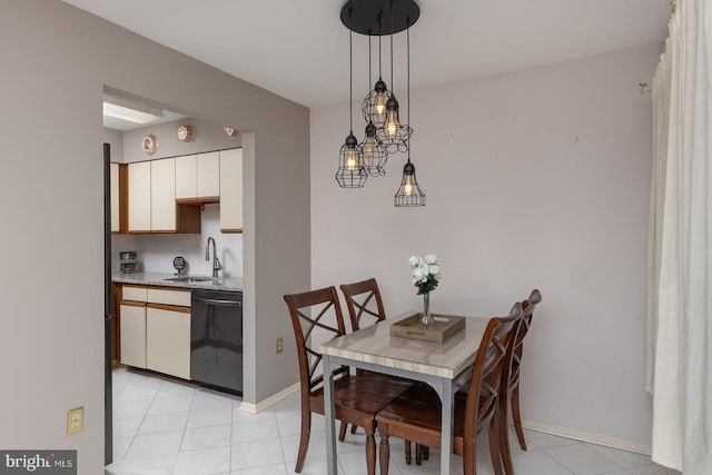 dining space featuring sink and light tile patterned floors