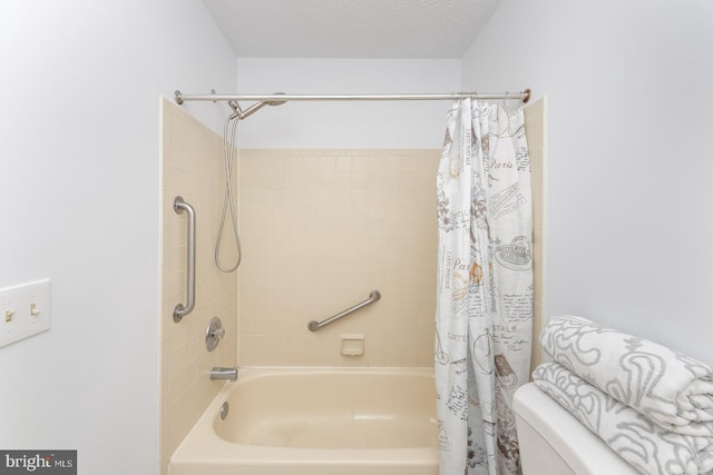 bathroom featuring toilet, a textured ceiling, and shower / bath combo with shower curtain