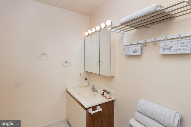 bathroom with vanity and a textured ceiling