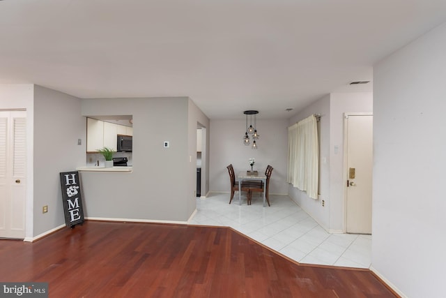 corridor featuring light tile patterned floors