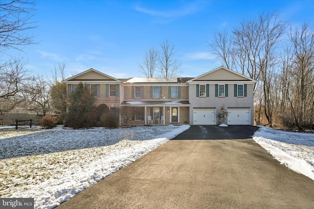 view of front of house featuring covered porch and a garage