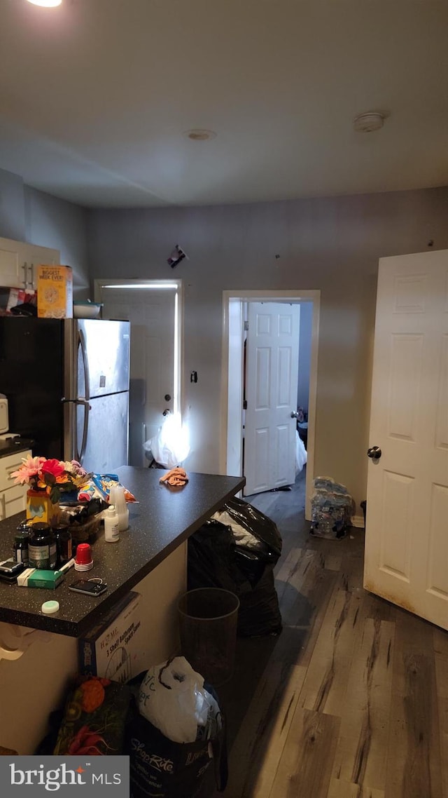 kitchen with stainless steel fridge and hardwood / wood-style flooring