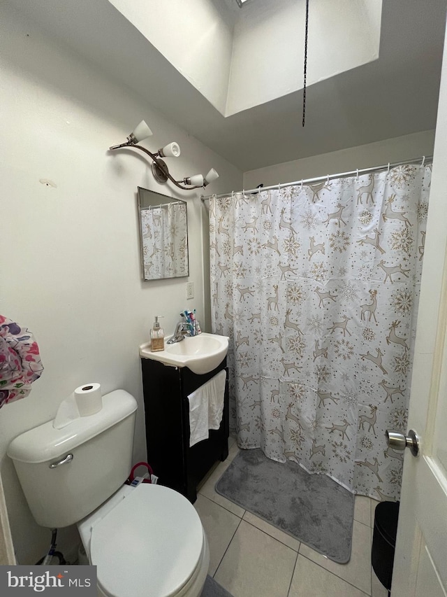 bathroom with tile patterned flooring, vanity, toilet, and curtained shower