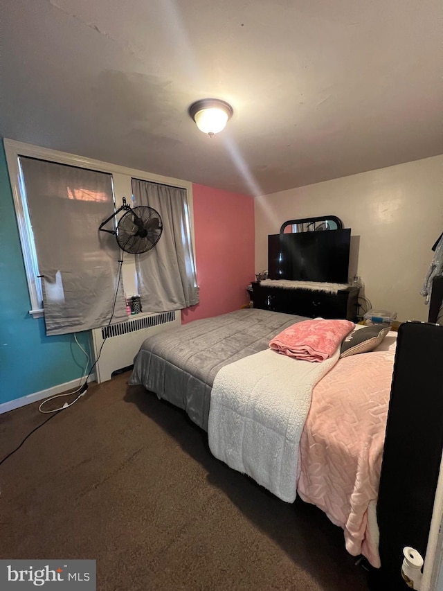 bedroom with carpet flooring and radiator