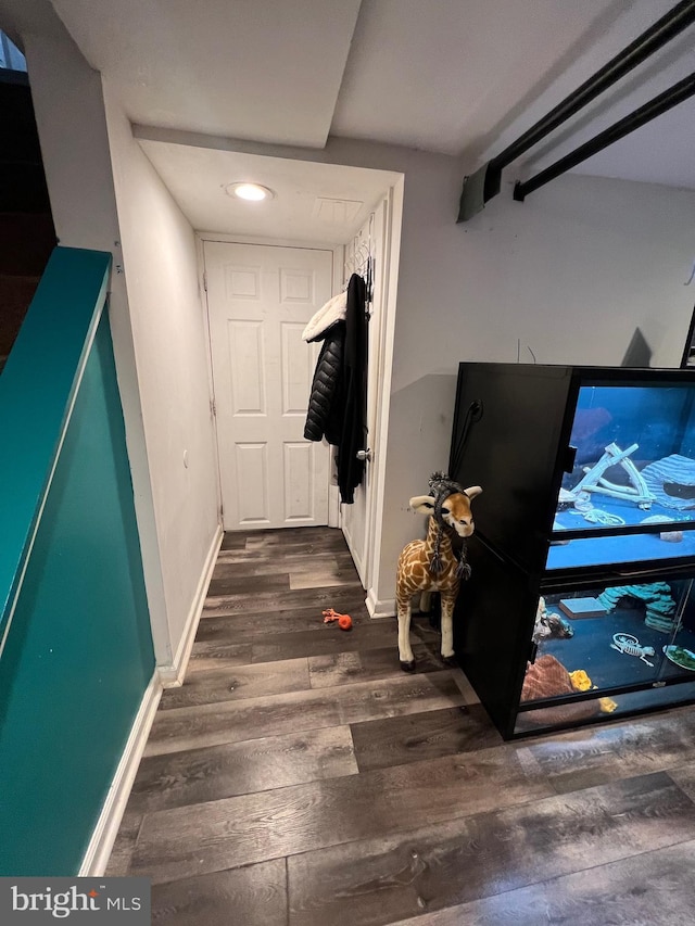 corridor featuring dark hardwood / wood-style floors