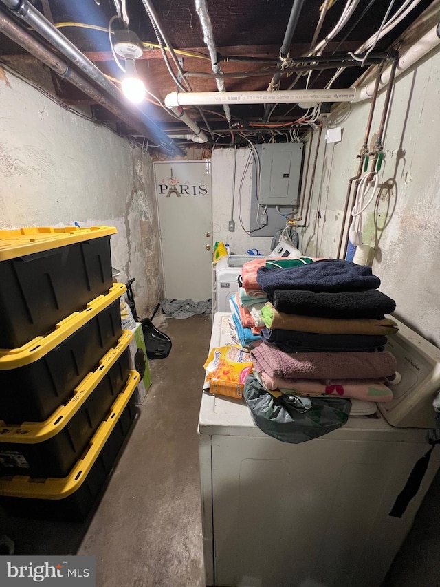 basement with washer and clothes dryer and electric panel