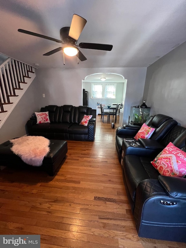 living room featuring ceiling fan and hardwood / wood-style flooring