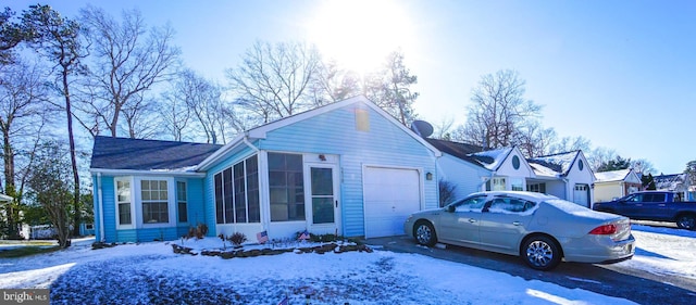 view of front of house with a garage and a sunroom