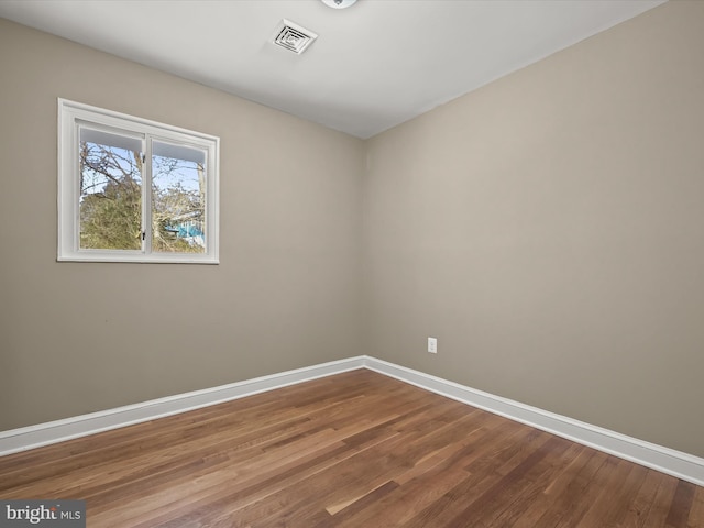 spare room with hardwood / wood-style floors