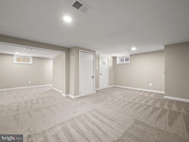 basement featuring light carpet