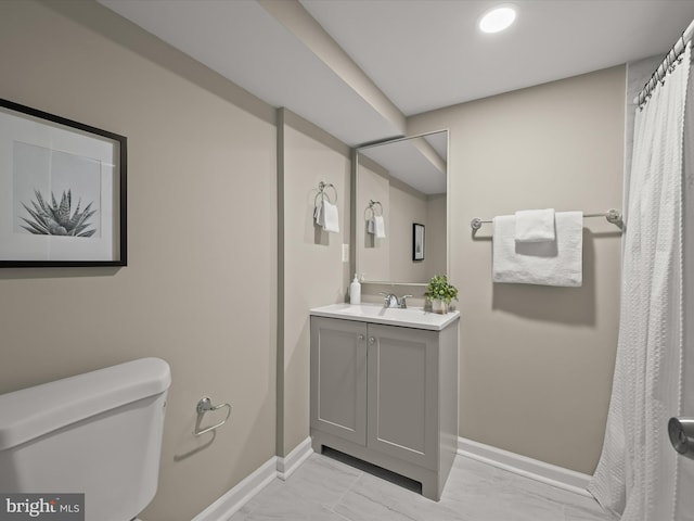 bathroom with toilet, tile patterned flooring, and vanity