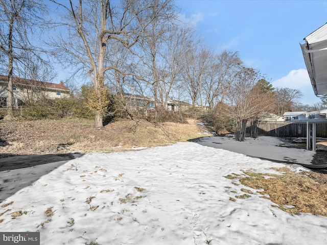 snowy yard with a patio area