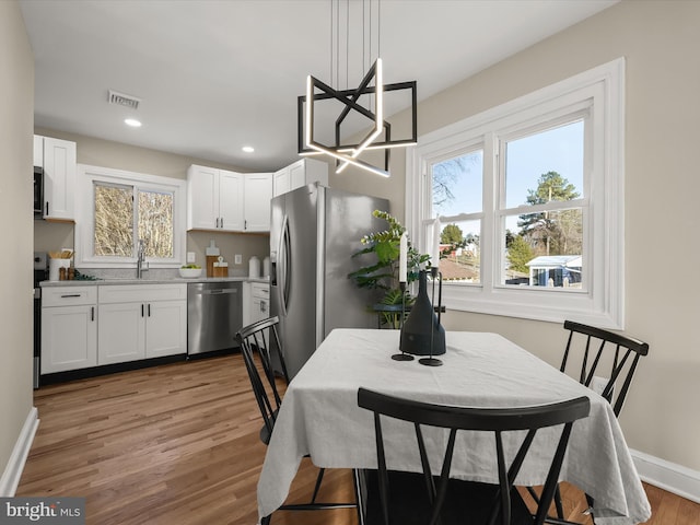 dining area with sink and hardwood / wood-style flooring