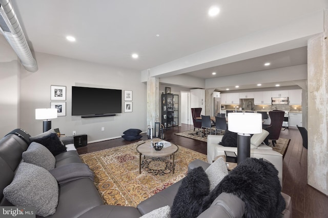 living room featuring dark hardwood / wood-style floors and sink