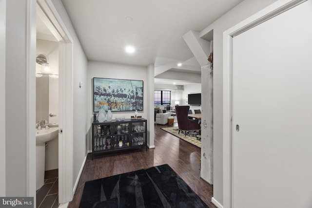 corridor with dark hardwood / wood-style floors