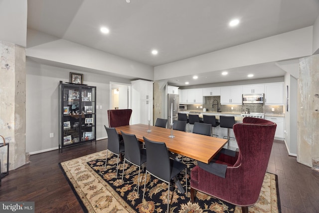 dining room featuring dark hardwood / wood-style flooring and sink