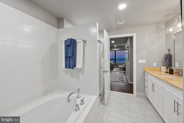 bathroom featuring tile patterned floors, vanity, and independent shower and bath