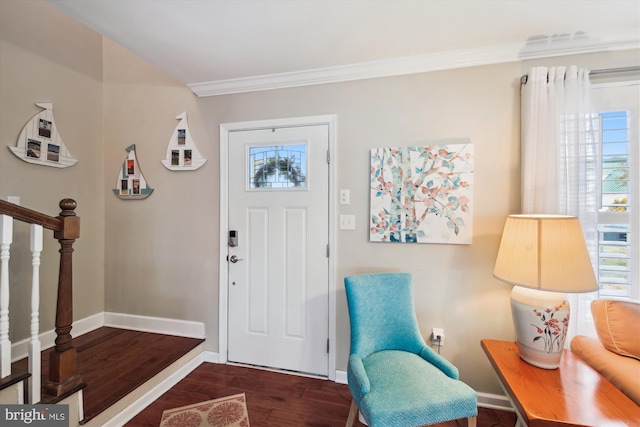 foyer entrance with dark hardwood / wood-style floors and crown molding