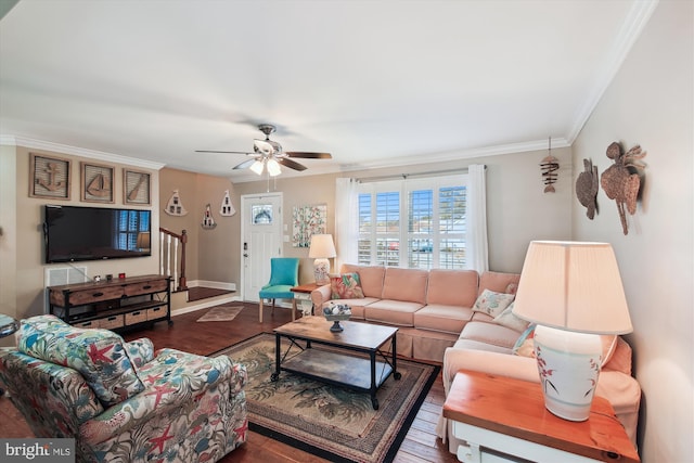 living room with hardwood / wood-style flooring, ornamental molding, and ceiling fan