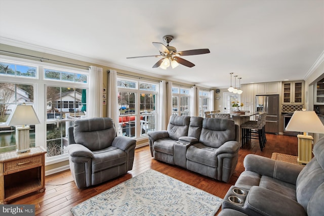 living room with dark hardwood / wood-style floors, ceiling fan, and ornamental molding