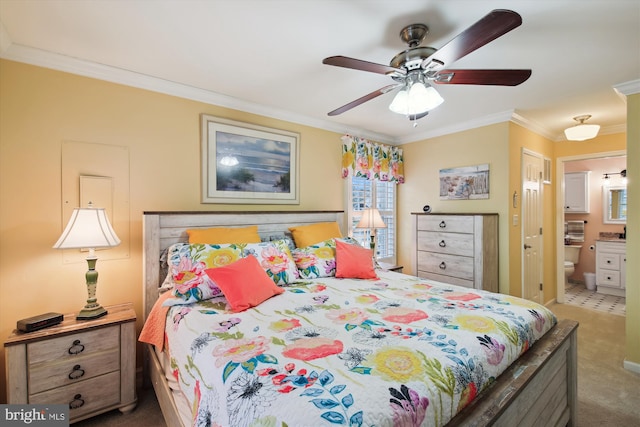 carpeted bedroom with ceiling fan, connected bathroom, and ornamental molding