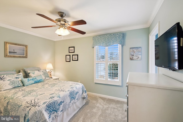 carpeted bedroom with ceiling fan and crown molding