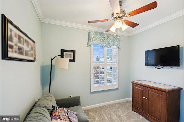 living area featuring ceiling fan, ornamental molding, and light carpet