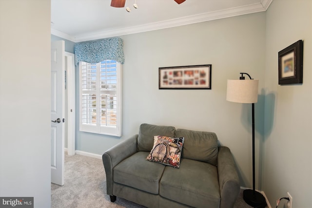 sitting room with crown molding, light colored carpet, and ceiling fan