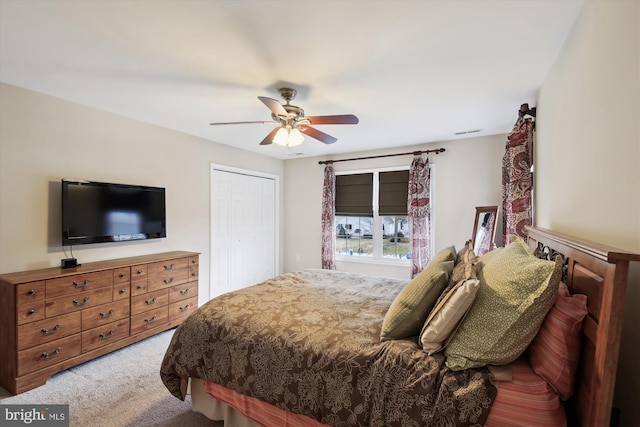 carpeted bedroom featuring a closet and ceiling fan