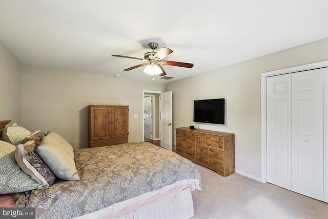 bedroom featuring a closet, ceiling fan, and light colored carpet