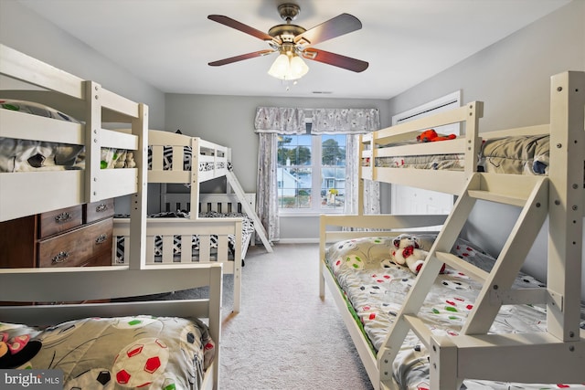 carpeted bedroom featuring ceiling fan and a wall mounted AC