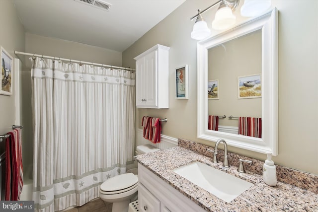 bathroom with toilet, tile patterned floors, and vanity