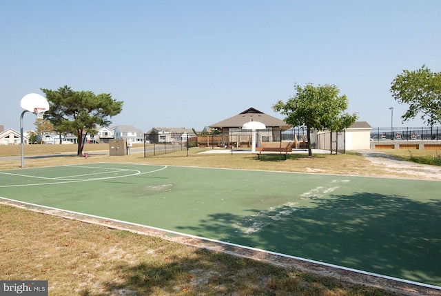 view of basketball court with a lawn