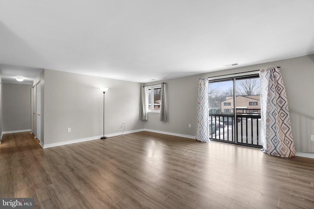 spare room with dark hardwood / wood-style flooring