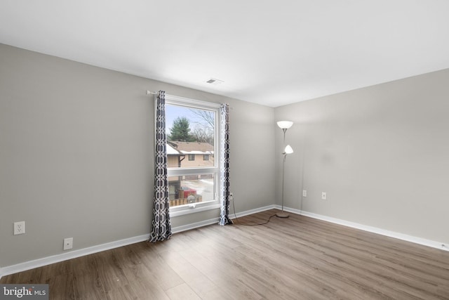 spare room featuring wood-type flooring