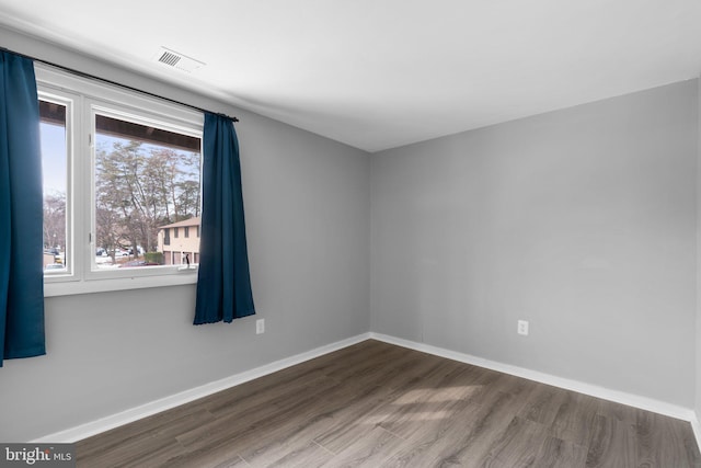 unfurnished room with wood-type flooring